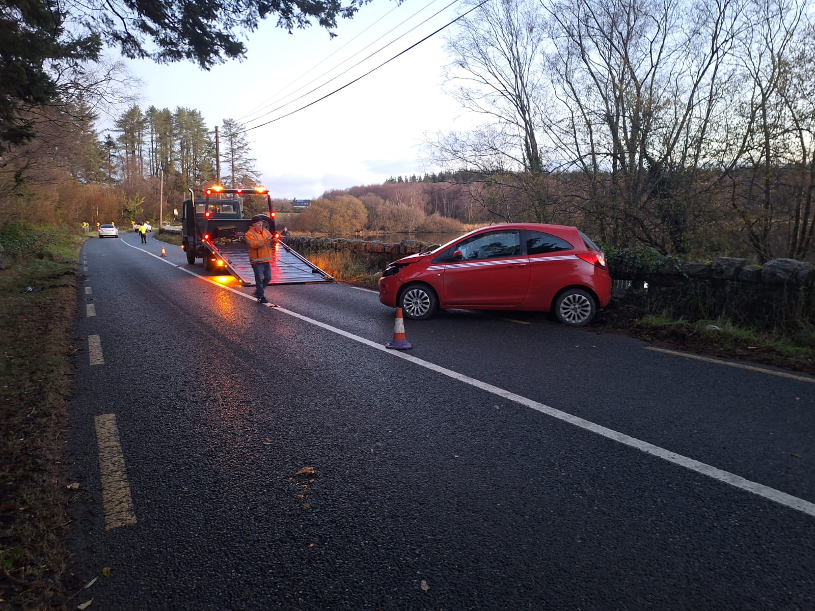 Tilt and slide recovery truck loading a vehicle