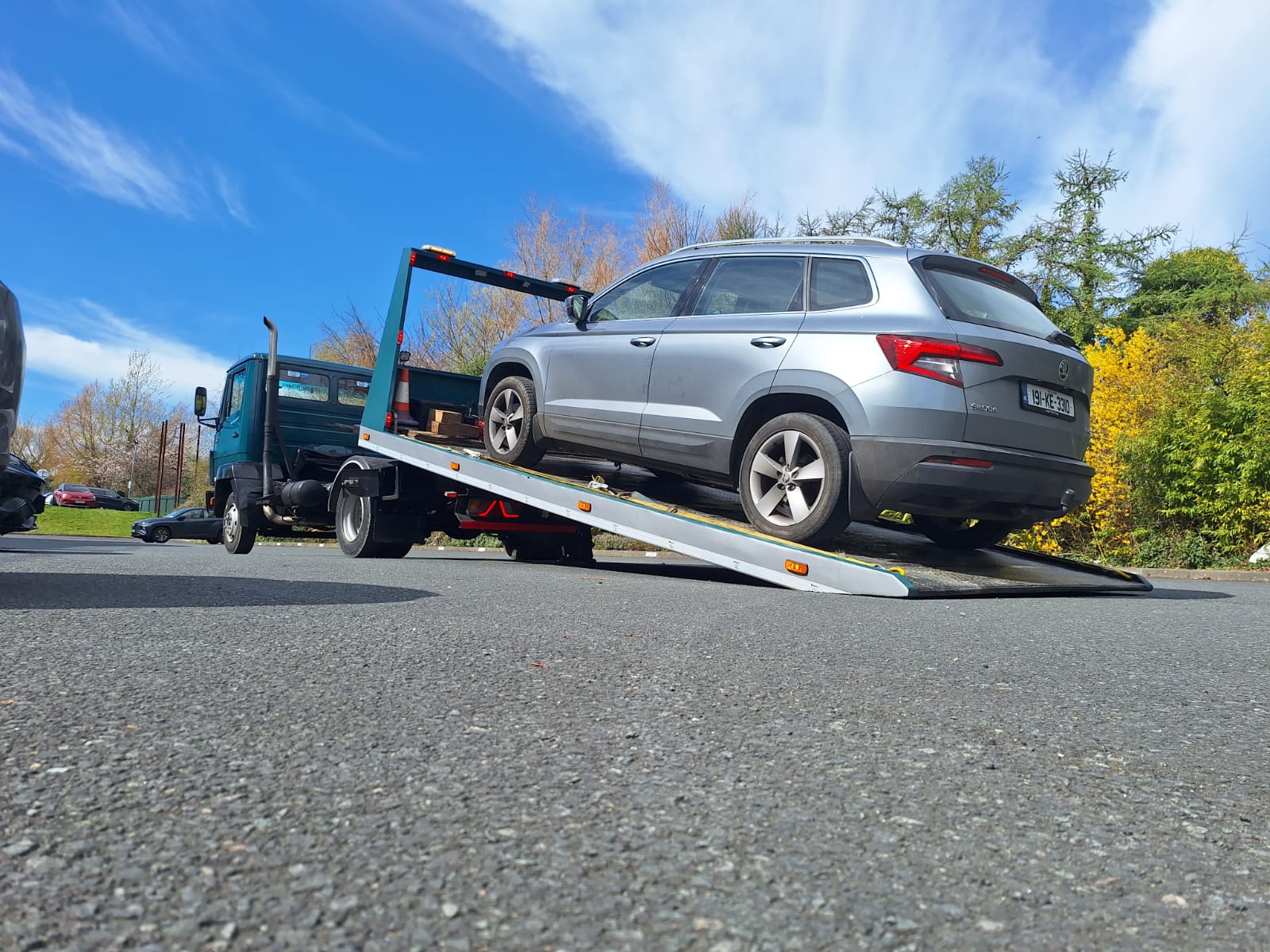 Tilt and slide recovery truck loading a vehicle in Ireland