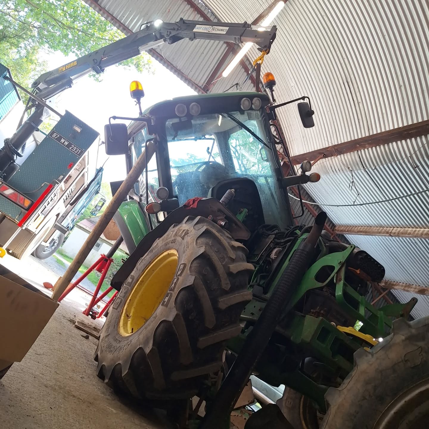 Tractor lifted by crane during machinery recovery in Ireland
